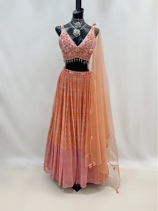 Peach Pink Flowy Printed lehenga With Embroidered Top